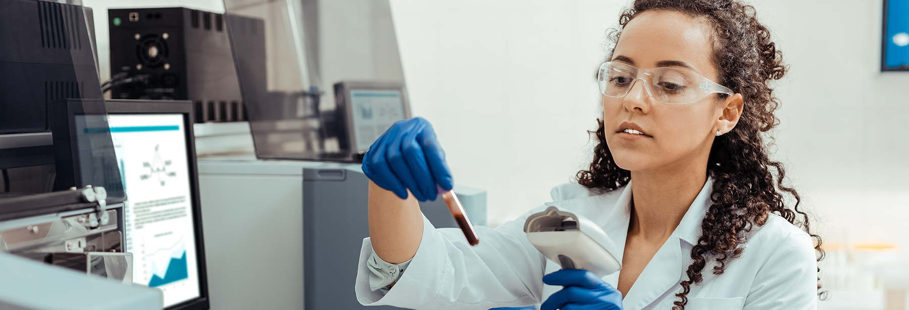 female lab technician scanning a test tube