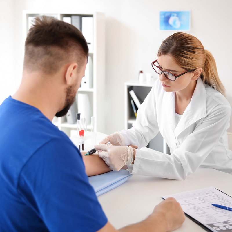 Male Patient getting blood drawn from female provider