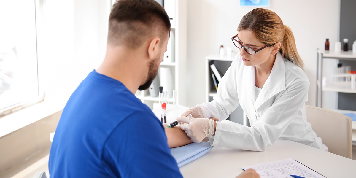 Female Provider Drawing Blood from Male Patient