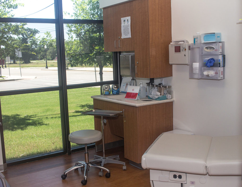 Exam room with exam bed and floor to ceiling window