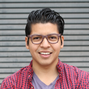 Photo of a smiling Latino male in glasses