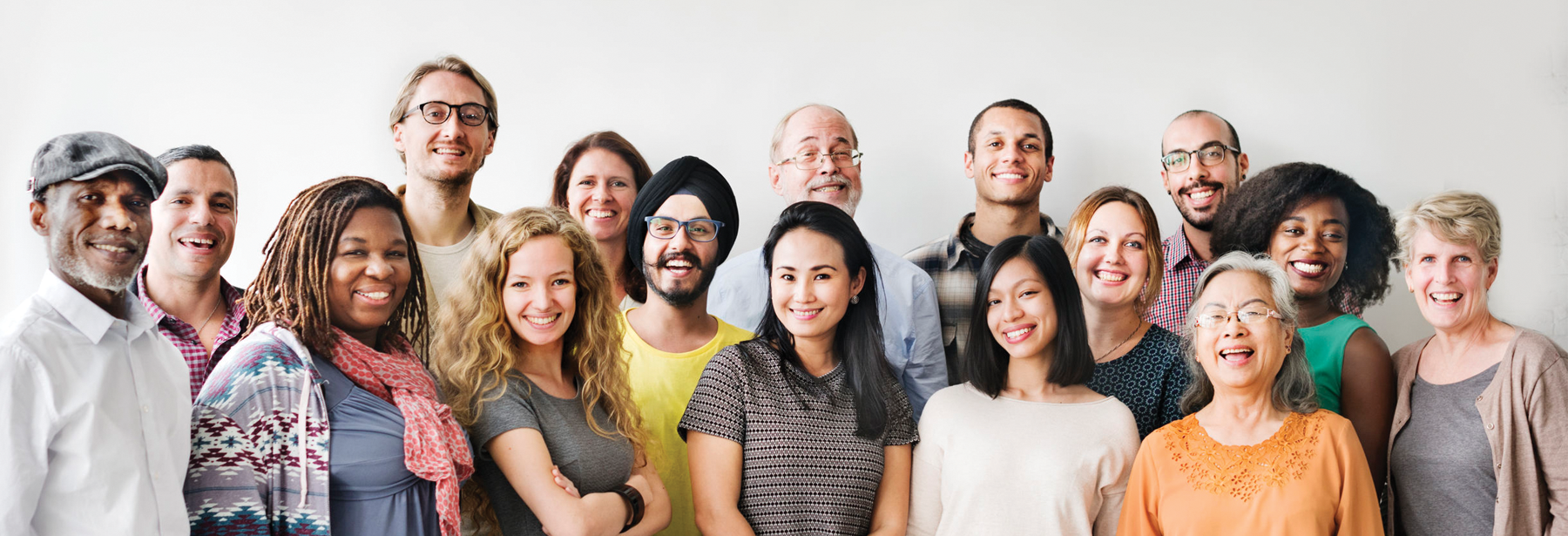 Large group of diverse people smiling against a white background
