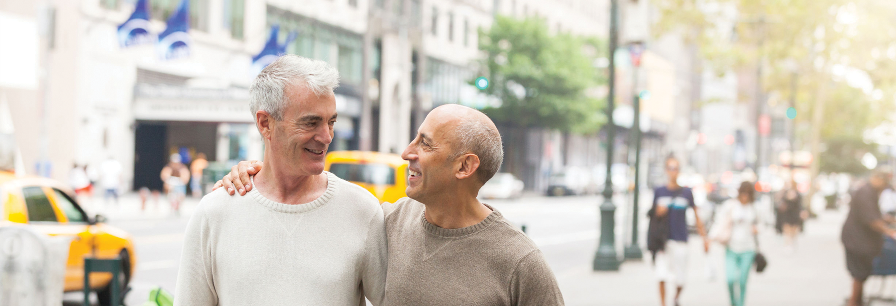 Two older white gay males walking down the street