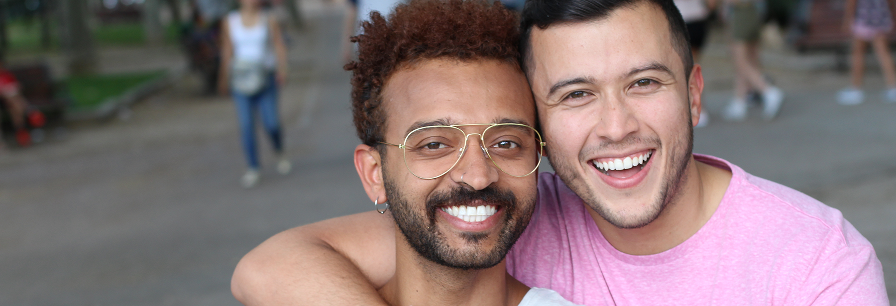 Two male friends smiling outdoors