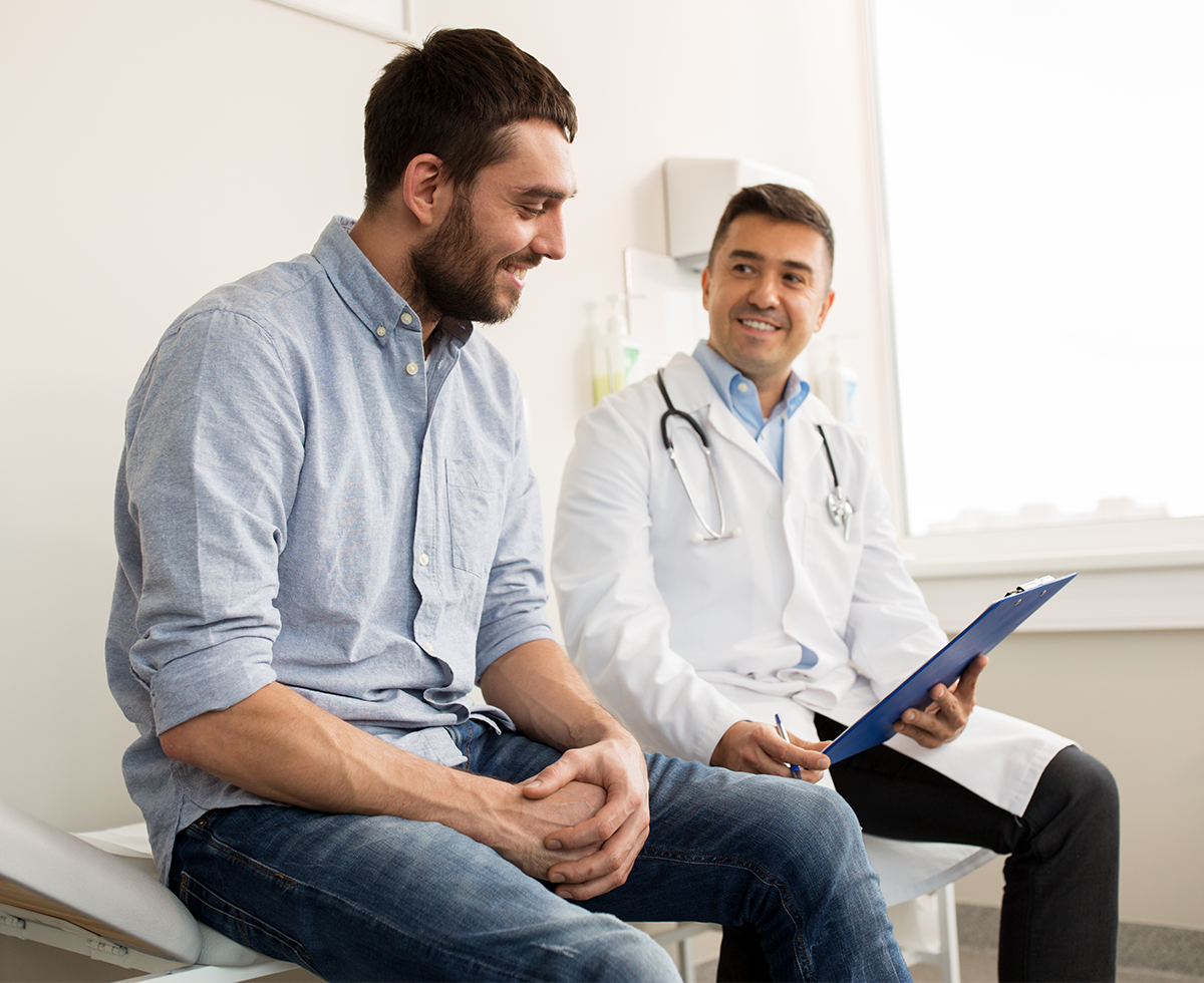 Male patient in consultation with male provider