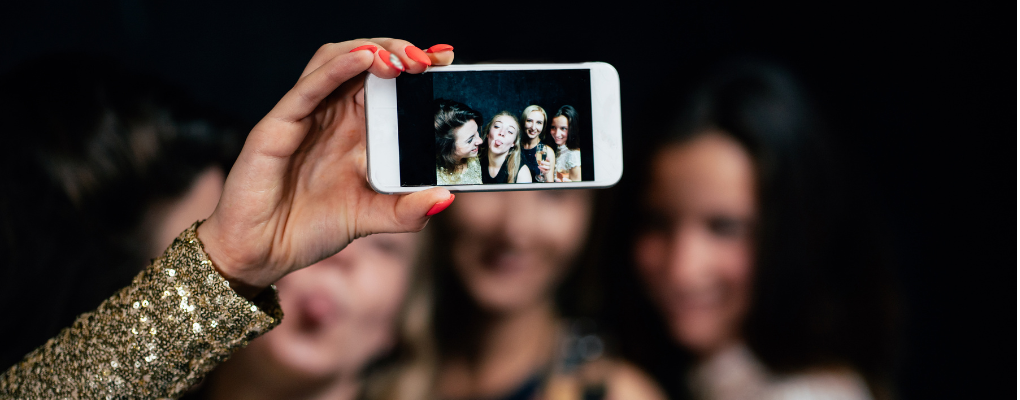 a group of young women taking a selfie - happy hour at Woody's