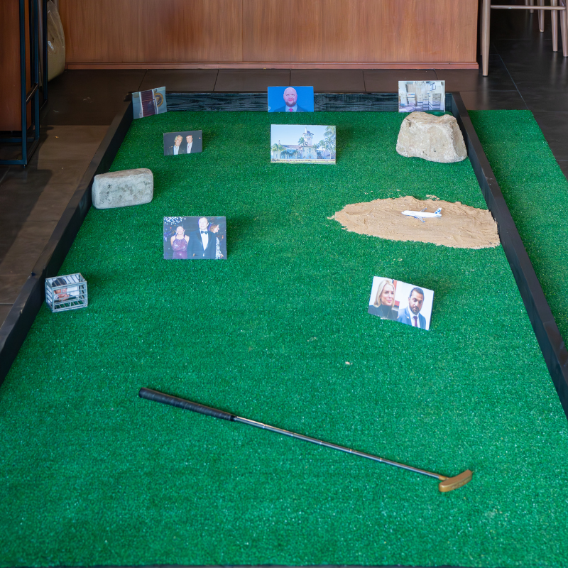 putt-putt clover classic 2025 hole that uses pictures of political figures as obstacles at Alexandre's