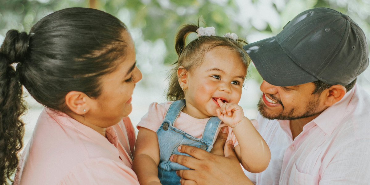 a latino father and mother with their toddler daughter - affordable community healthcare