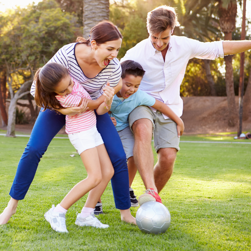 a family playing an informal game of soccer - healthy family habits