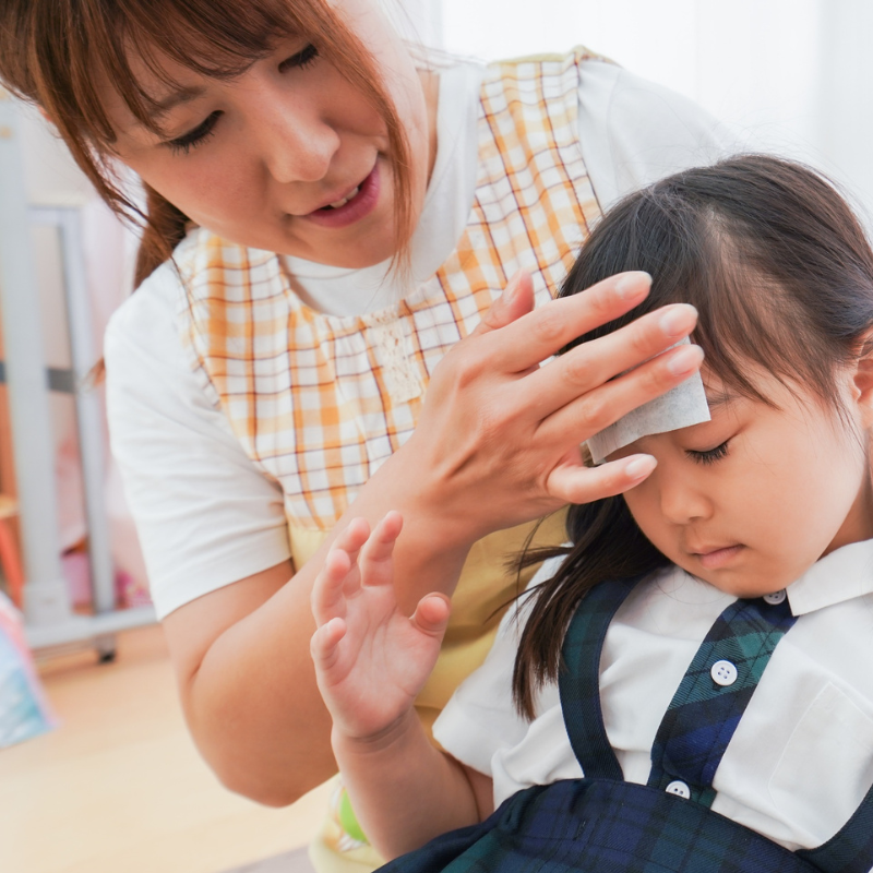 a mom giving her little girl a cold compress - At-Home Allergy Remedies That Are Safe for Kids